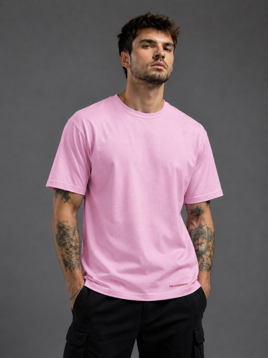 Man wearing baby pink oversized graphic t-shirt front view