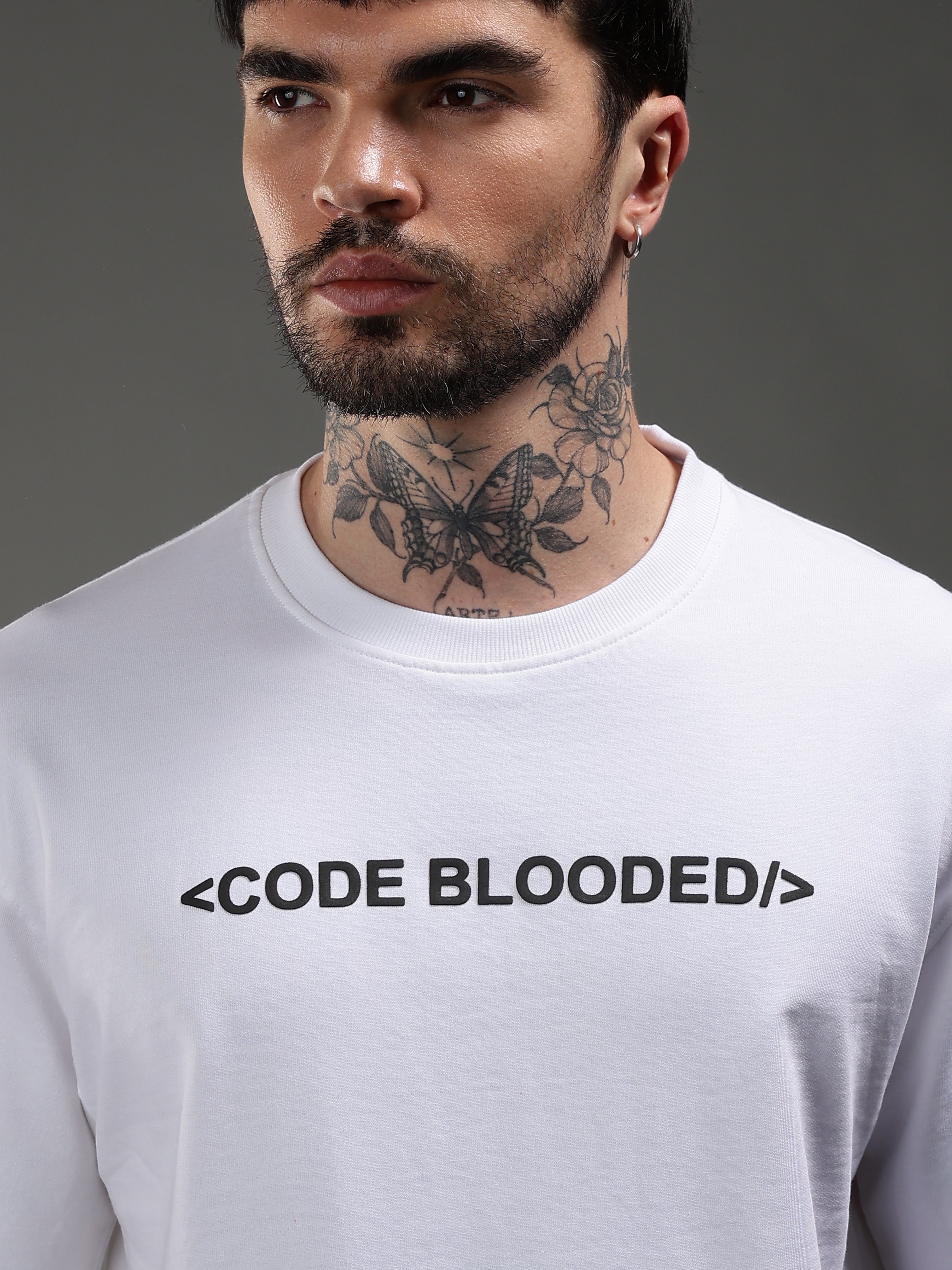 Model wearing white Code Blooded oversized t-shirt front streetwear India