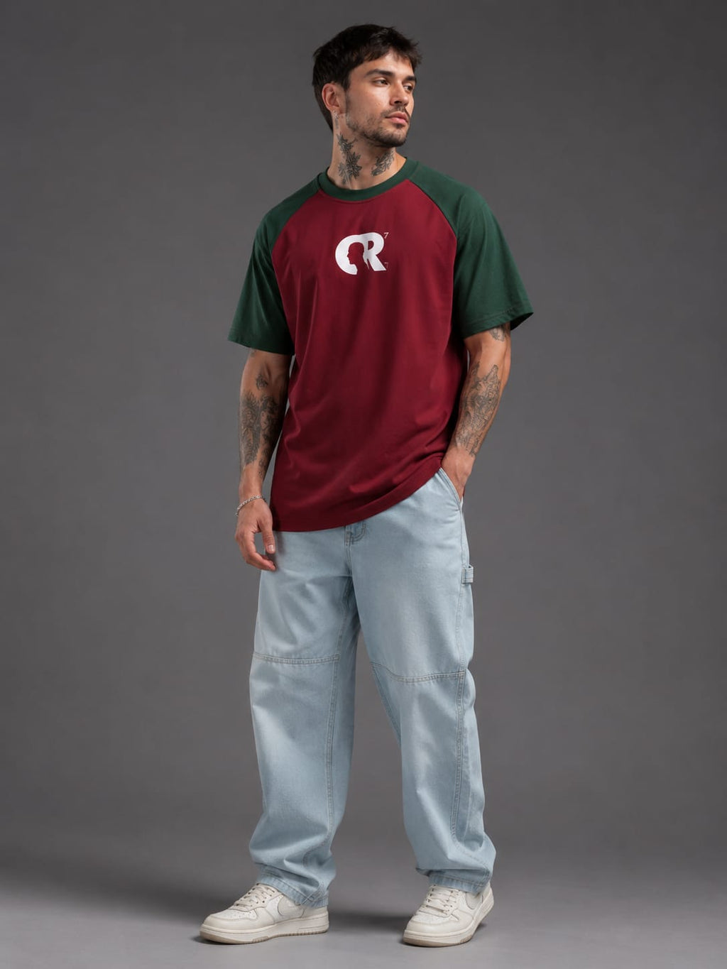 Man wearing CR7 GOAT oversized maroon and green football t-shirt front view