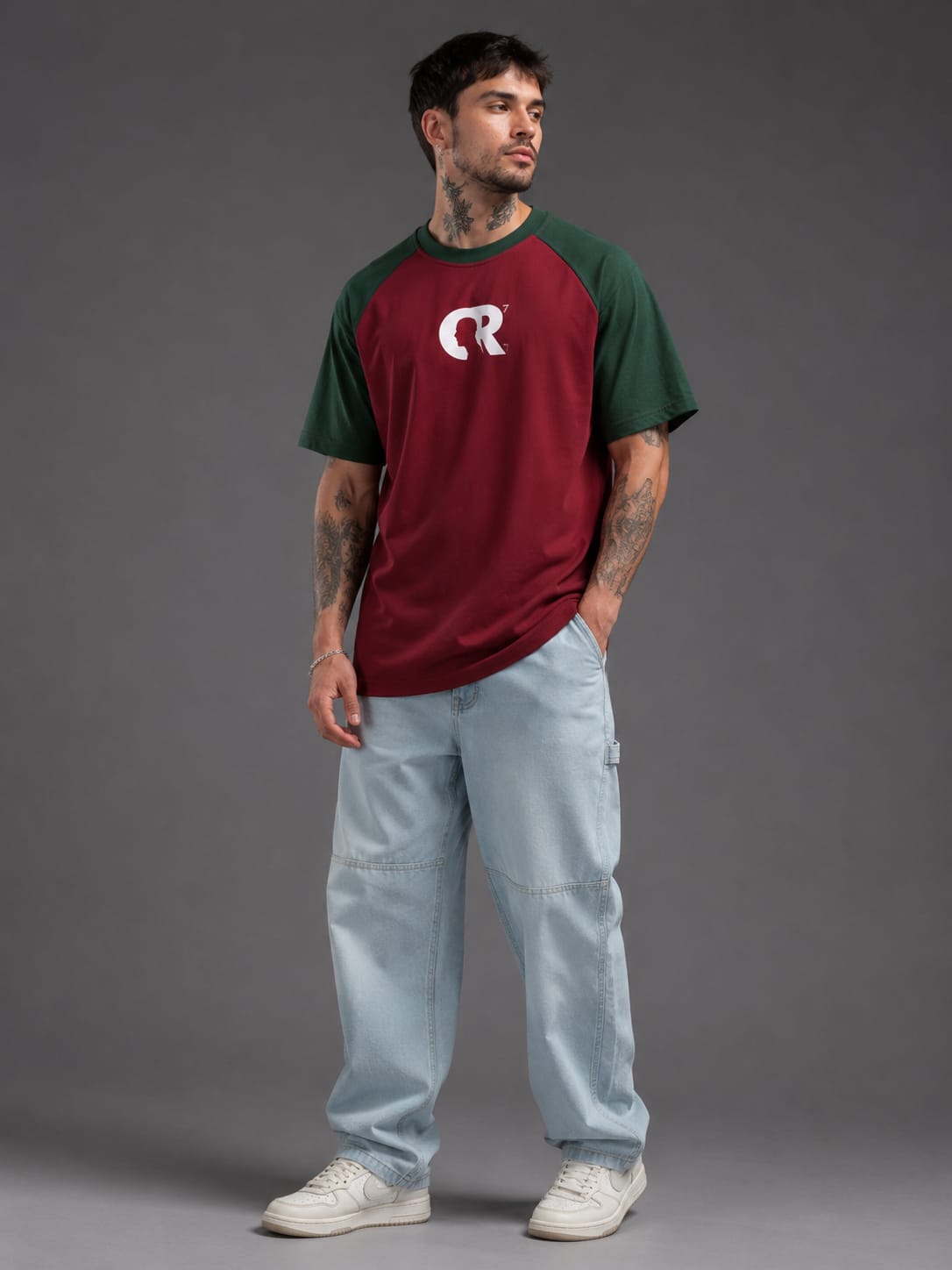 Man wearing CR7 GOAT oversized maroon and green football t-shirt front view