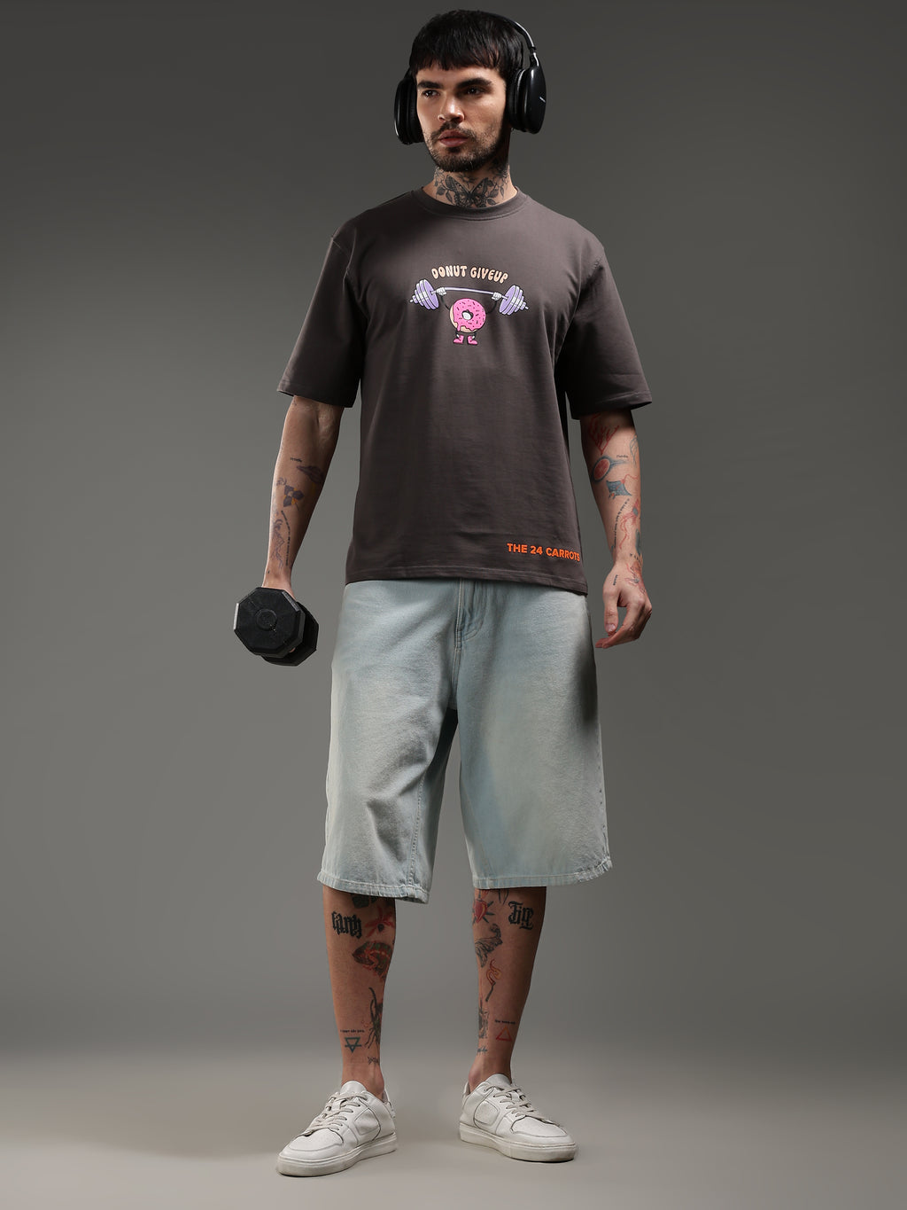 Model holding dumbbell wearing oversized gym t-shirt motivational workout