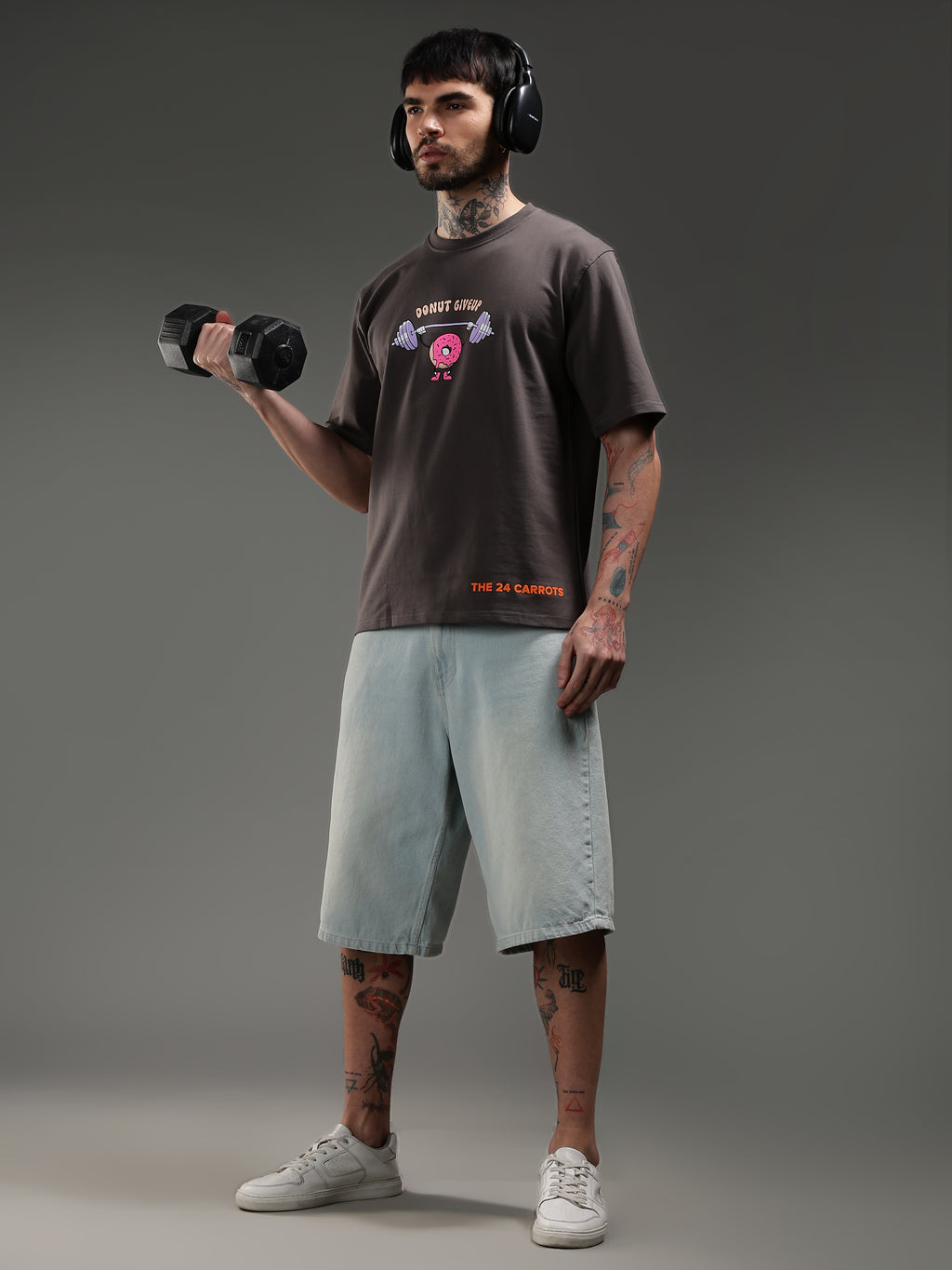 Model lifting dumbbell wearing Donut Give Up gym t-shirt workout style
