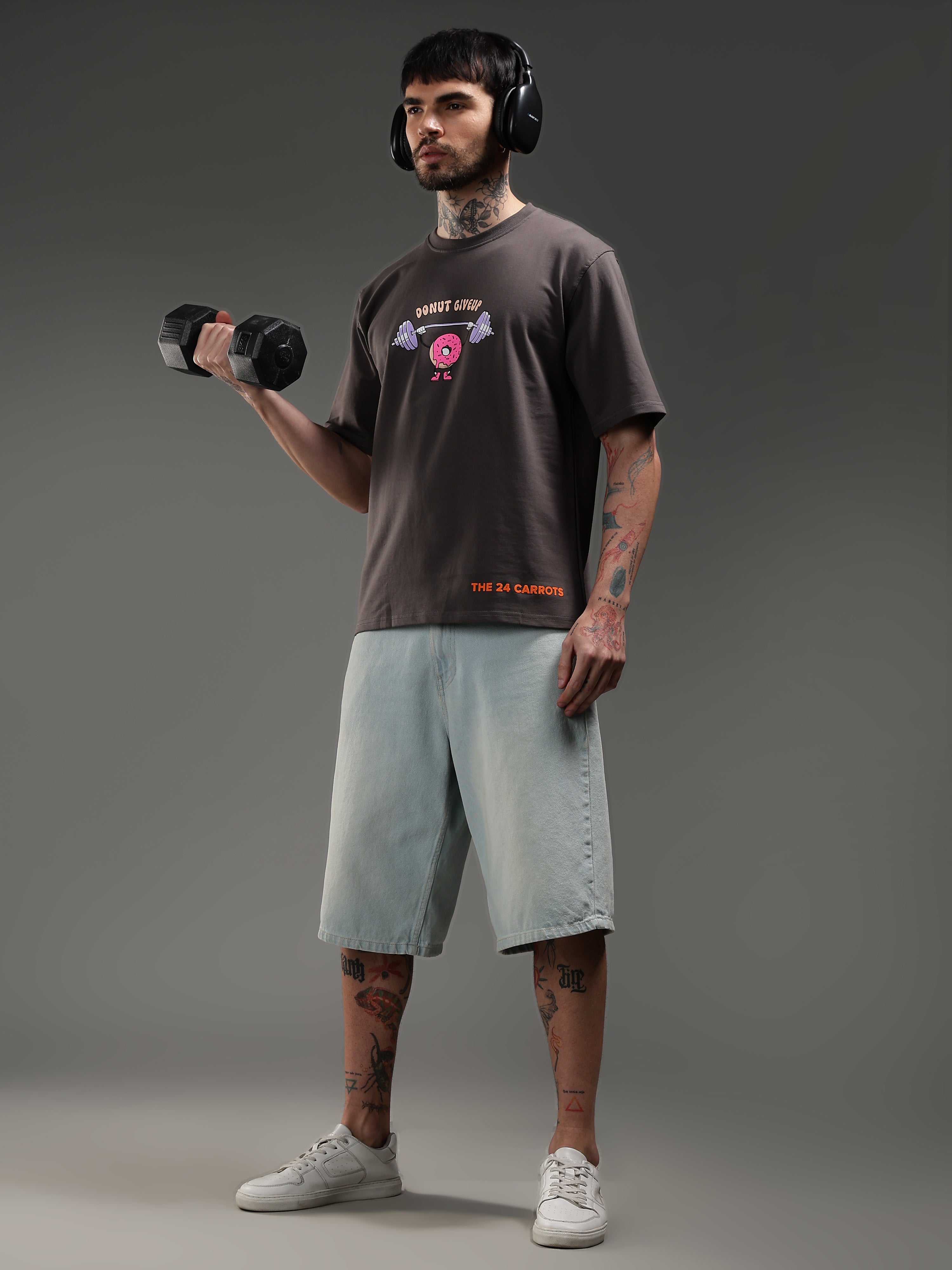 Model lifting dumbbell wearing Donut Give Up gym t-shirt workout style