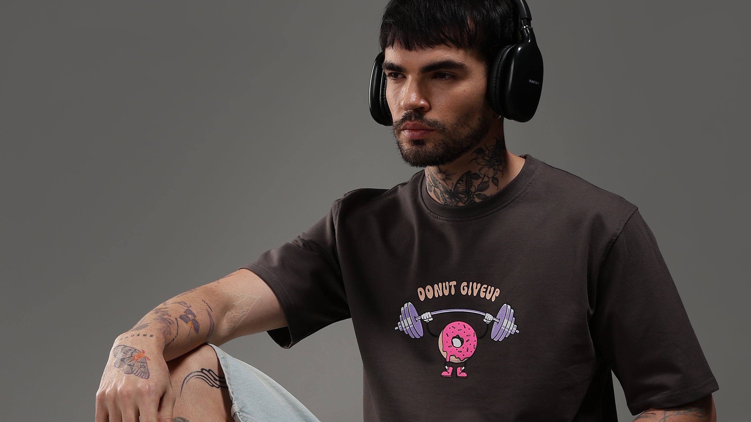Model sitting on floor wearing oversized gym t-shirt streetwear style