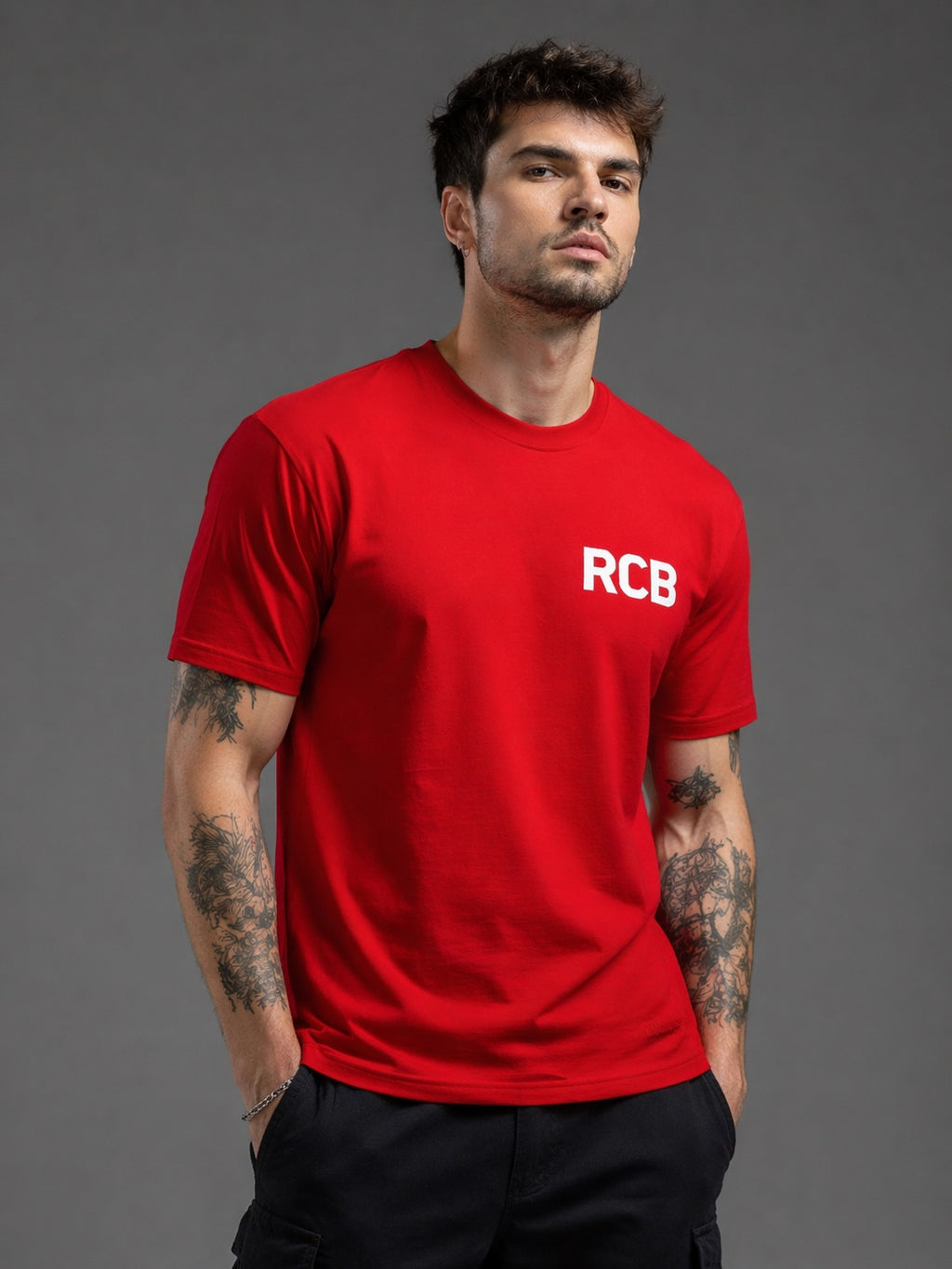 Man wearing red RCB oversized t-shirt front view