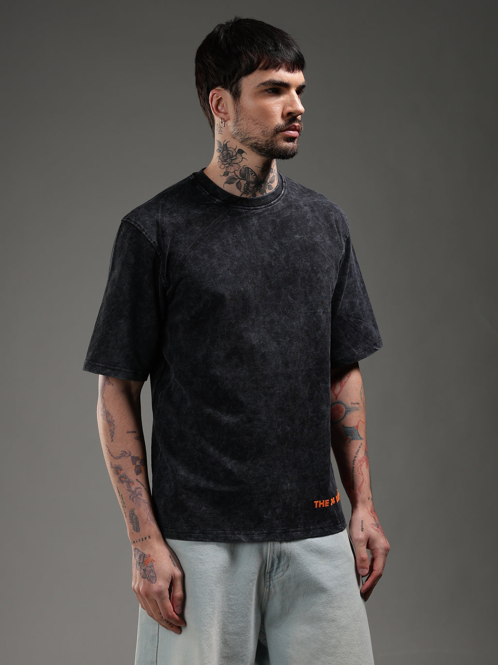 Model wearing black acid wash oversized t-shirt side view biker style