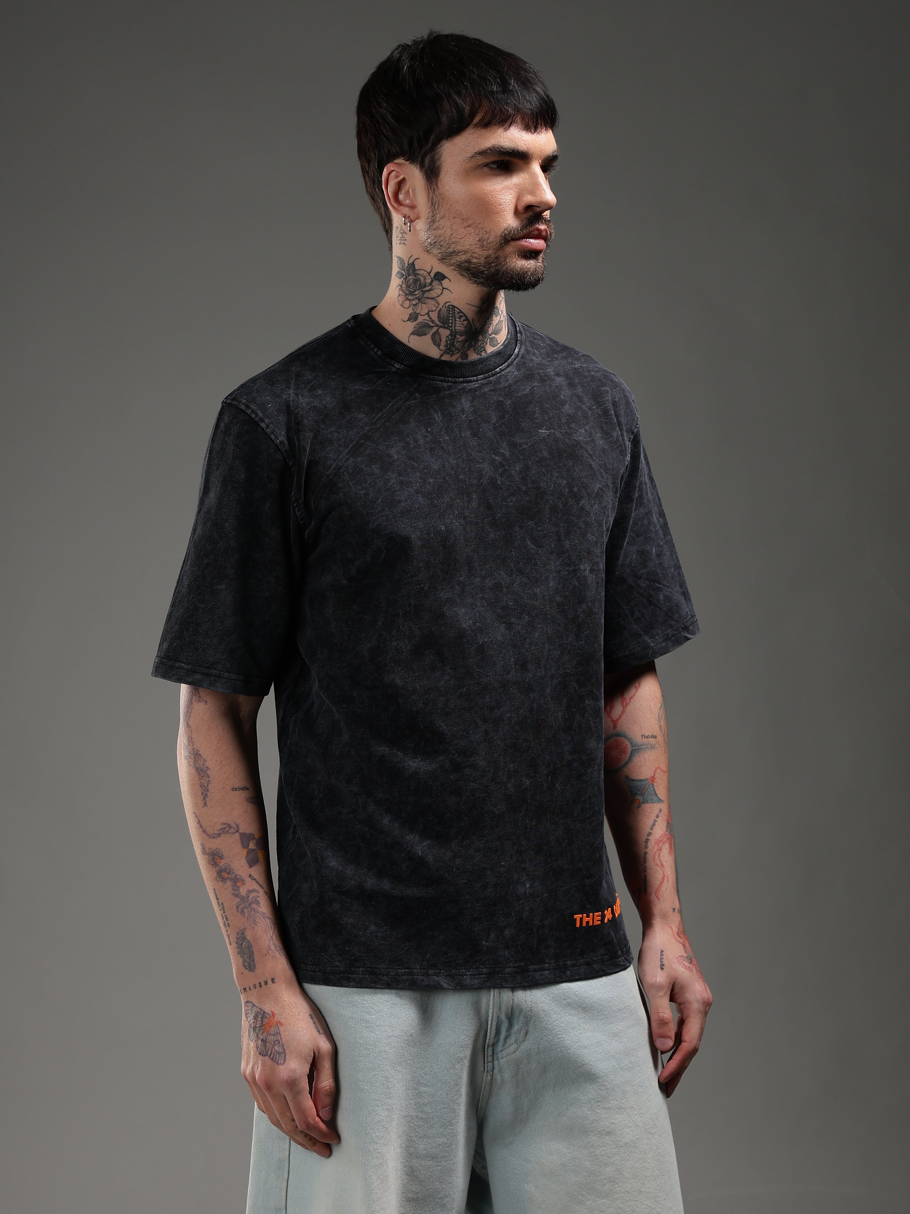 Model wearing black acid wash oversized t-shirt side view biker style