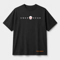 SNKR HEAD oversized off black t-shirt front view with minimal sneaker-inspired graphic by The 24 Carrots.